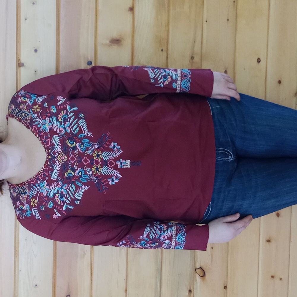 Silk screened to look embroidered poly blend silky shirt.